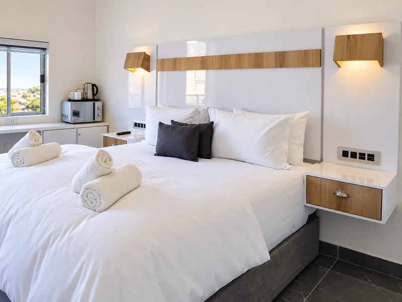 DreamSleep guest room with king-size bed, white linen and bedside lighting