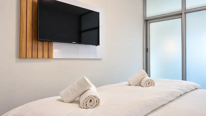 DreamSleep guest room with wall-mounted streaming TV and king bed